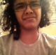 A black girl with glasses records herself sitting on a toilet. She intends to take a shit but ends up cutting a long, ripping fart that echoes throughout the bathroom.